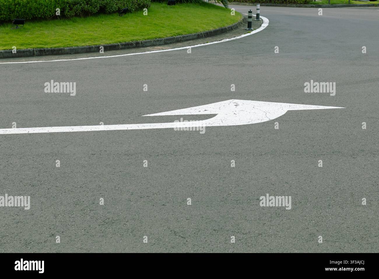 White Left Turn Direction Arrow Painted on Asphalt Road Stock Photo
