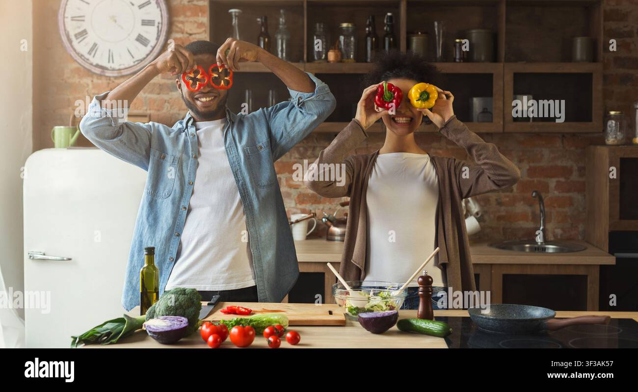 Happy black couple having fun in kitchen Stock Photo
