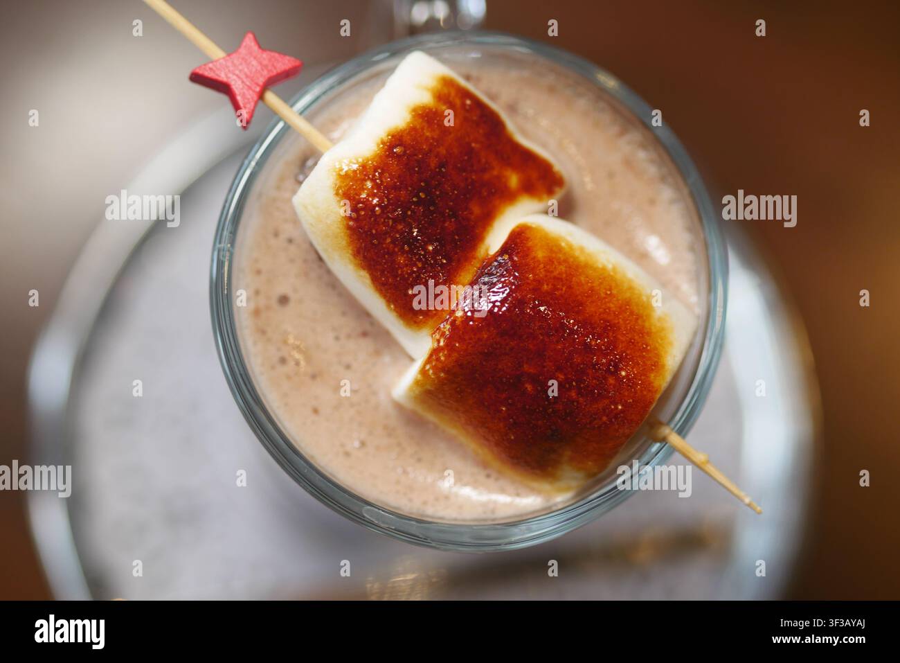 Marshmallows on a stick in a drink Stock Photo