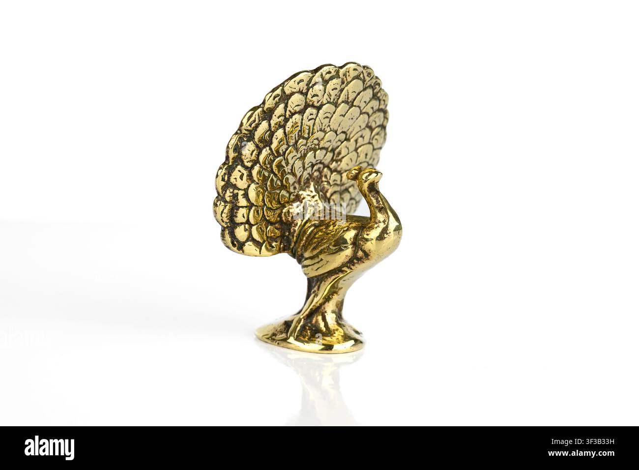Brass Peacock ornament on a white background Stock Photo