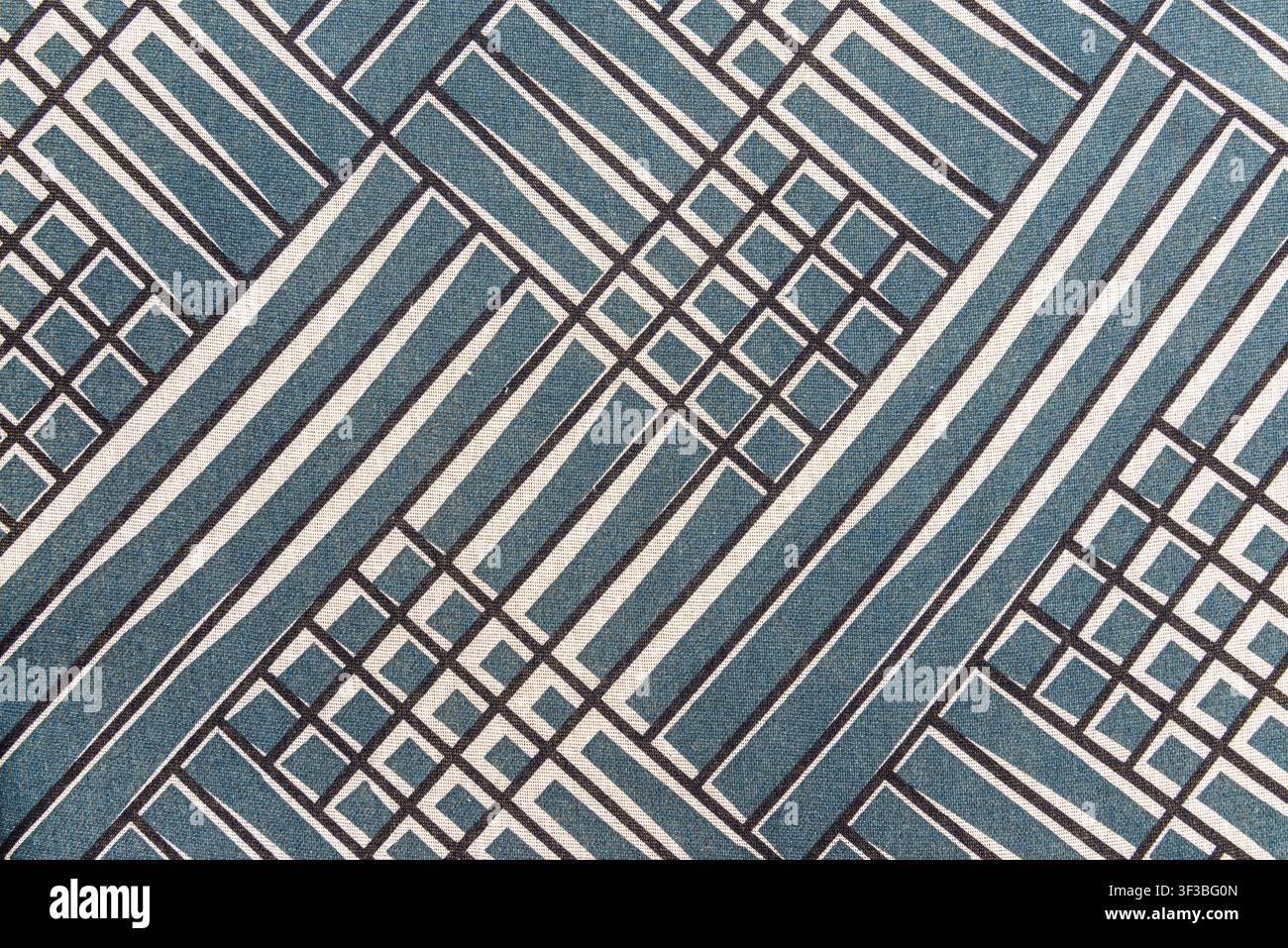 Blue and white textile texture featuring a modern architectural grid pattern. Geometric abstract pattern fabric background with copy space. Stock Photo