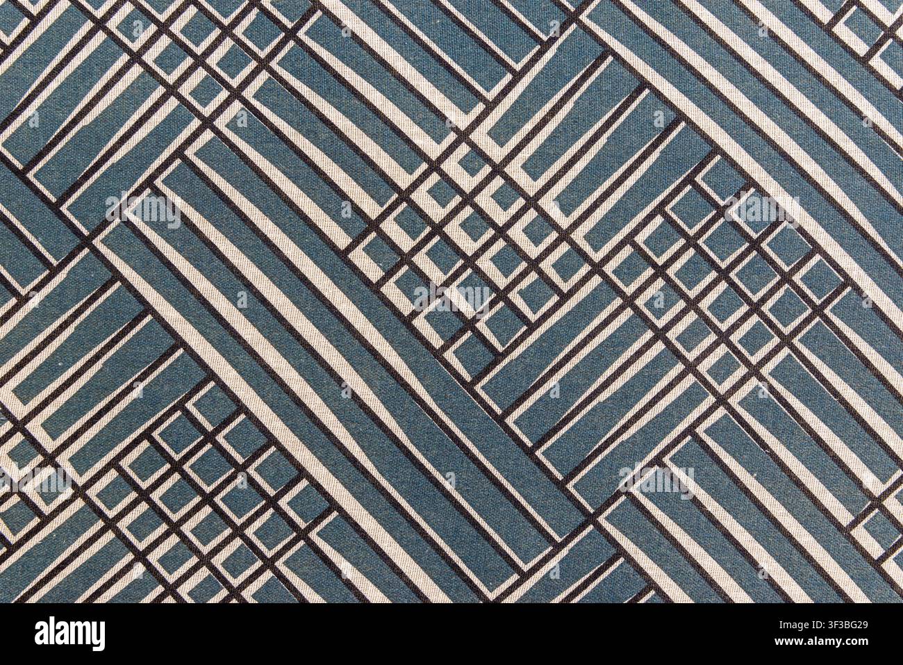 Blue and white textile texture featuring a modern architectural grid pattern. Geometric abstract pattern fabric background with copy space. Stock Photo