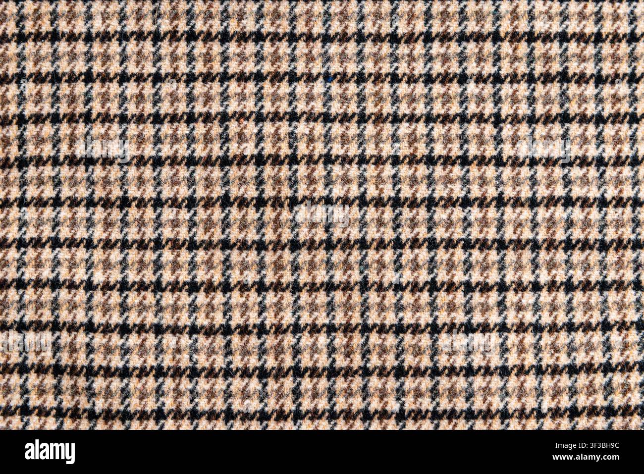 Brown plaid wool fabric texture background with copy space. Stock Photo