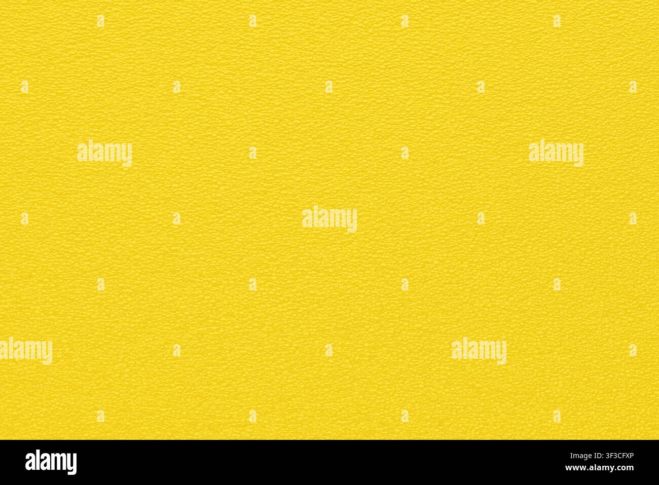 uniform plastic grainy bubble texture vibrant yellow background Stock Photo