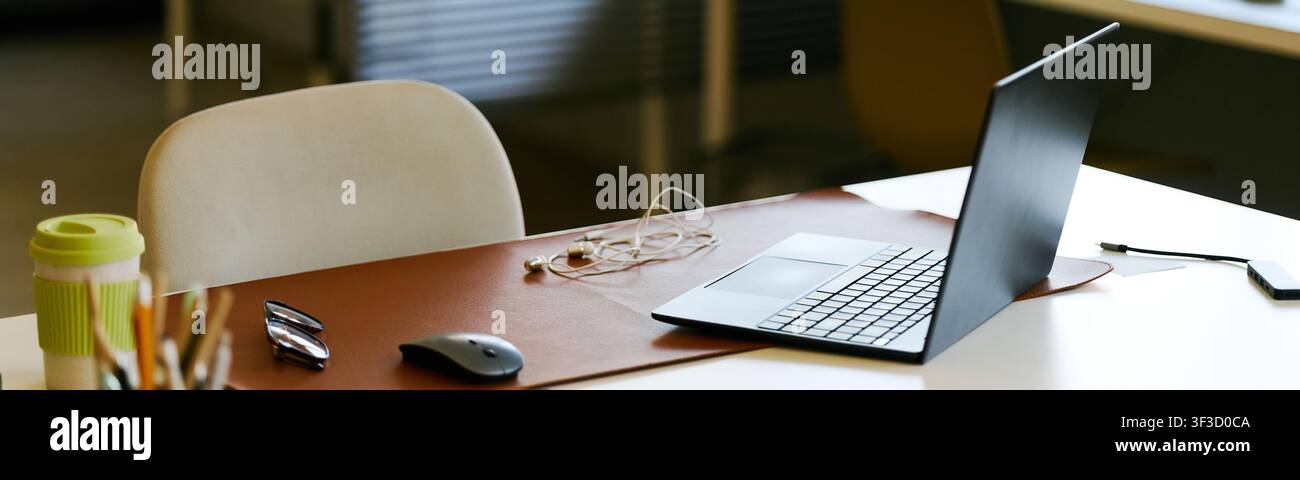 Modern Office Desk Featuring Laptop for Remote Work Setup Stock Photo