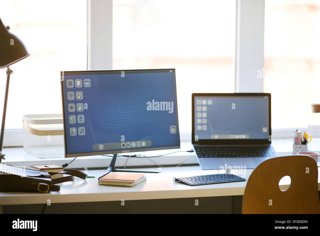 Home Office Workspace Featuring Desktop Computer and Laptop Stock Photo