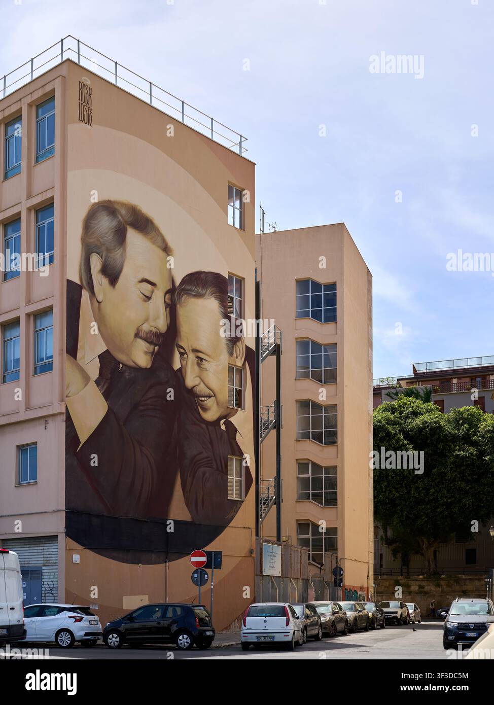 Large mural of two men on residential building in Palermo Stock Photo