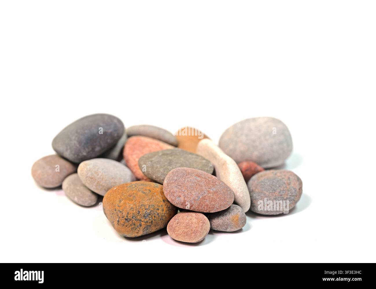Colorful pebbles against a white background Stock Photo
