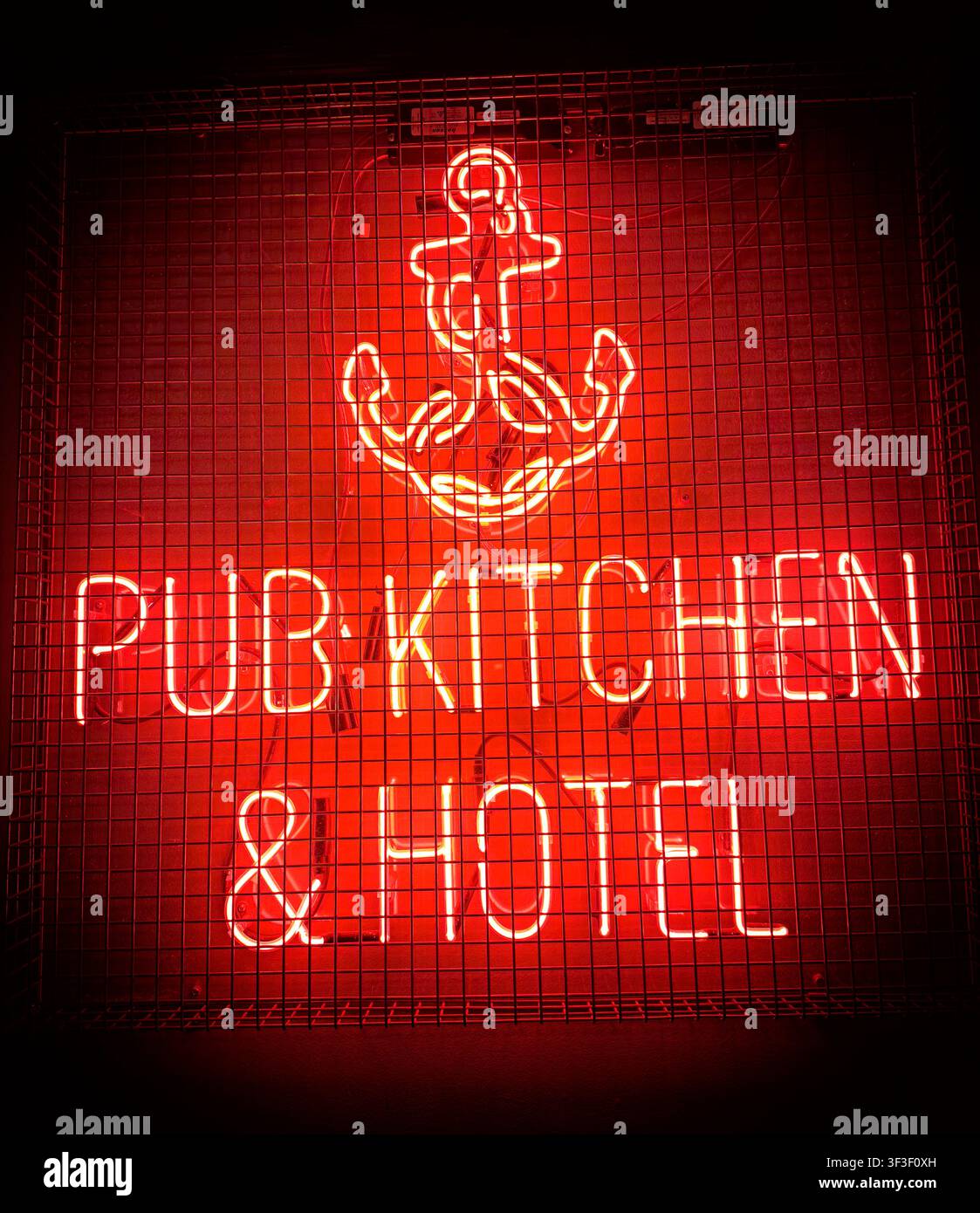 Neon Pub Kitchen and Hotel sign with anchor symbol at The Old Ship pub in London, England, UK. Stock Photo