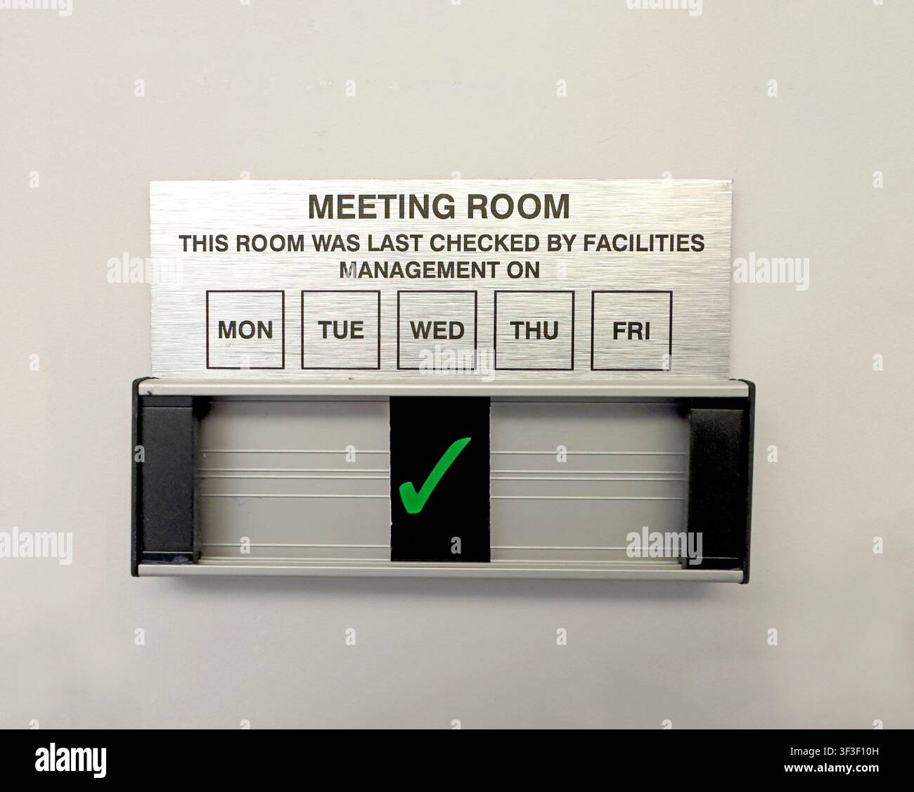 A meeting room facilities check sign with green tick,illustrating office management and debate over modern physical,remote MS Teams and hybrid working Stock Photo