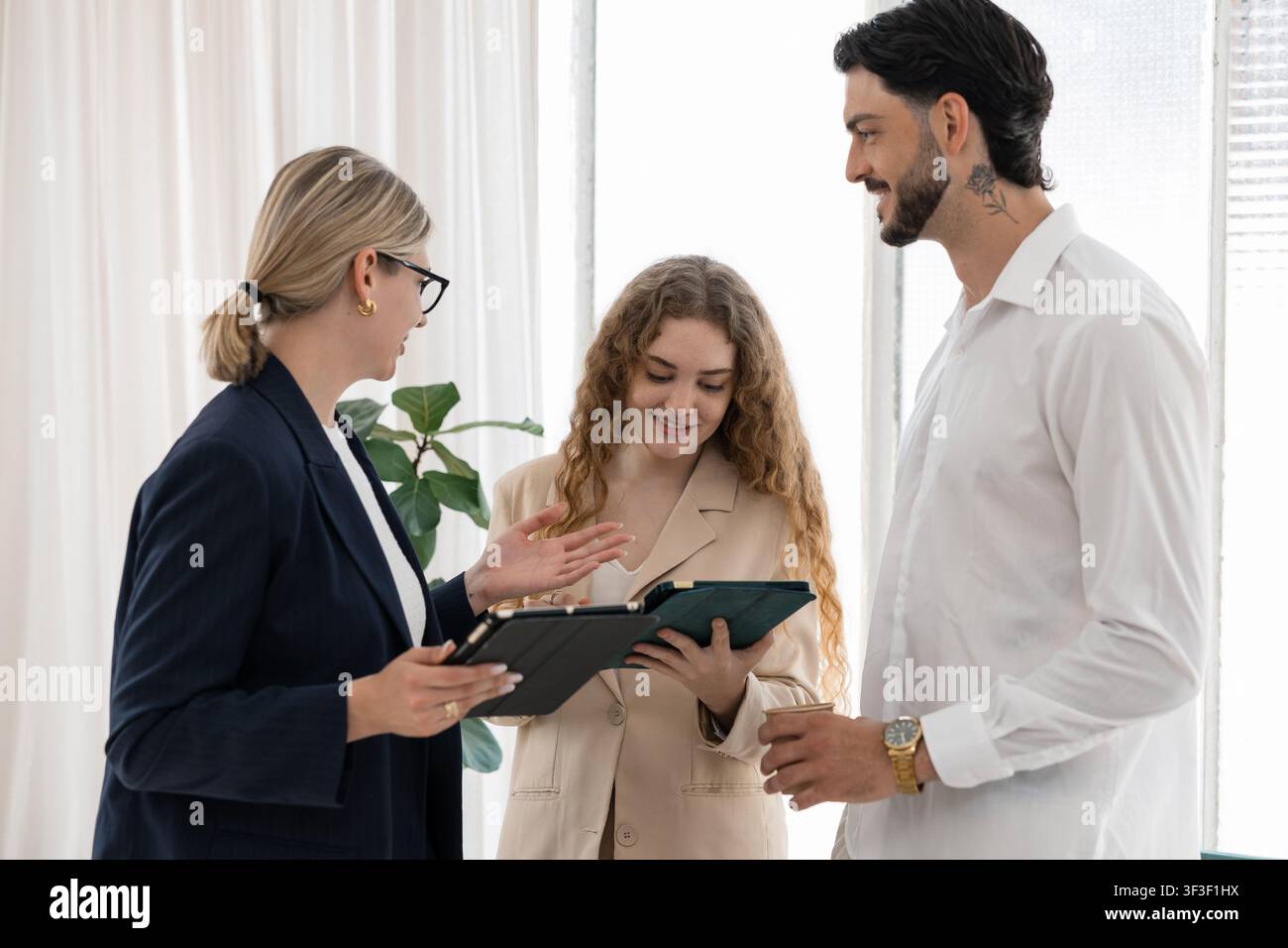 Business professionals discussing project using digital tablets Stock Photo