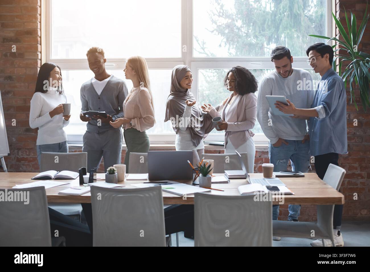 Friendly business team talking while having break Stock Photo