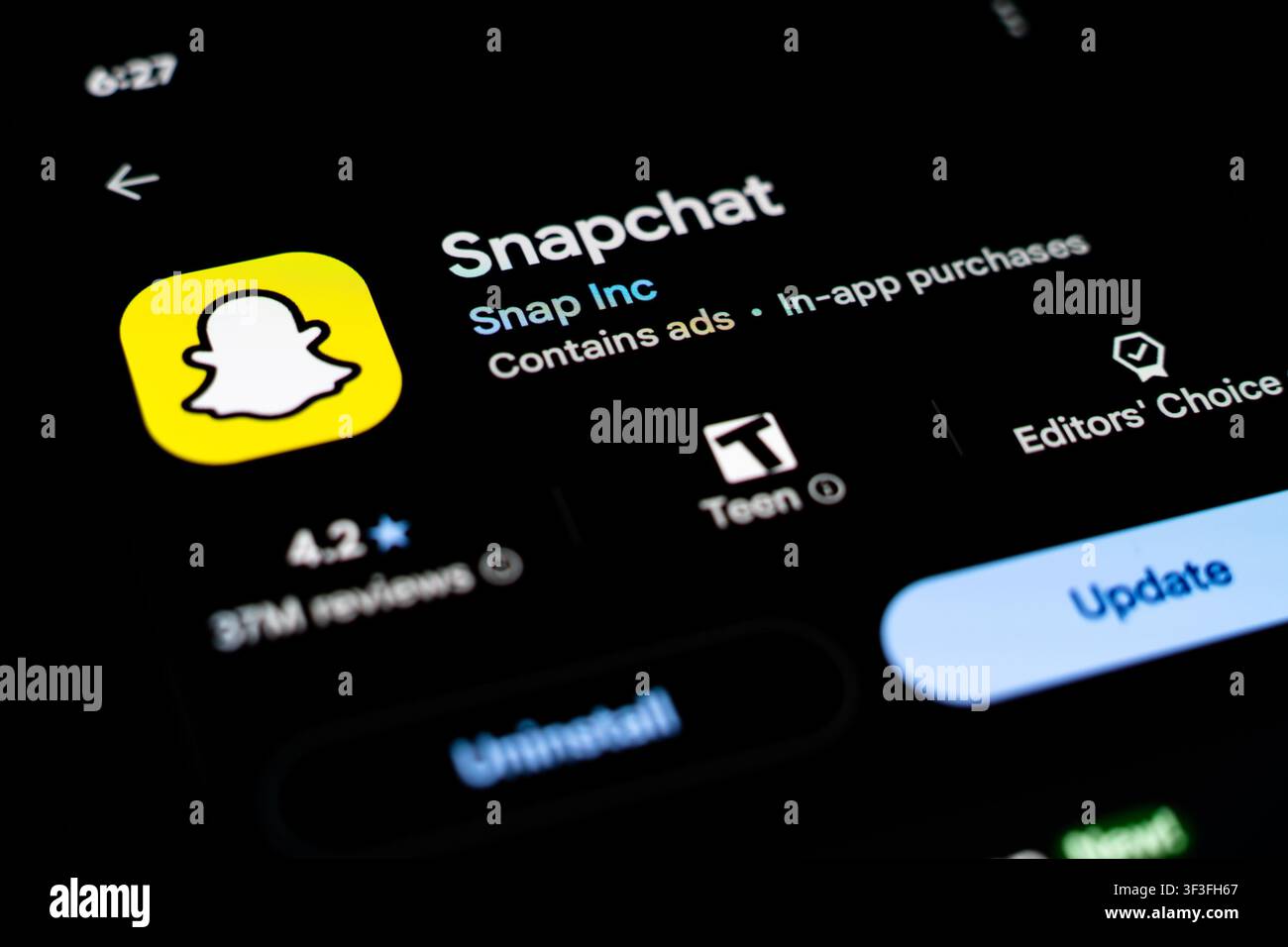 Snapchat App Listing Displayed on Smartphone Screen in Google Play Store Stock Photo