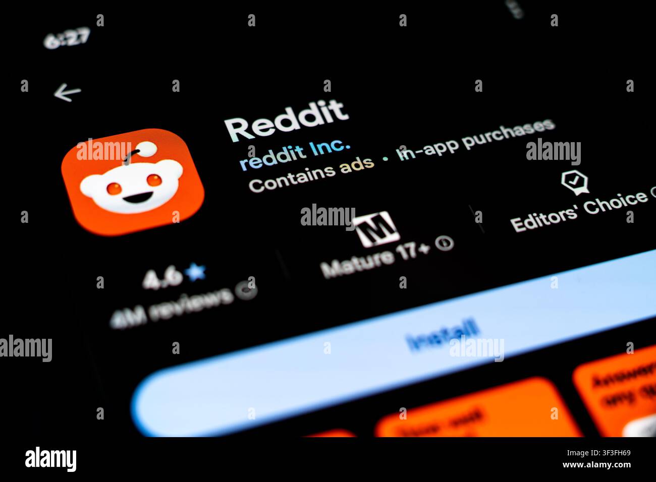 Reddit App Listing Displayed on Smartphone Screen in Google Play Store Stock Photo