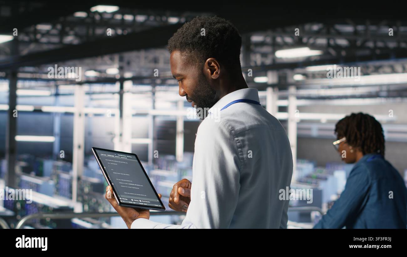 Data center programmers on industrial platform checking lines of code, collaborating on tasks. Server hub IT specialists visualizing large language model architecture using tablet and PC Stock Photo