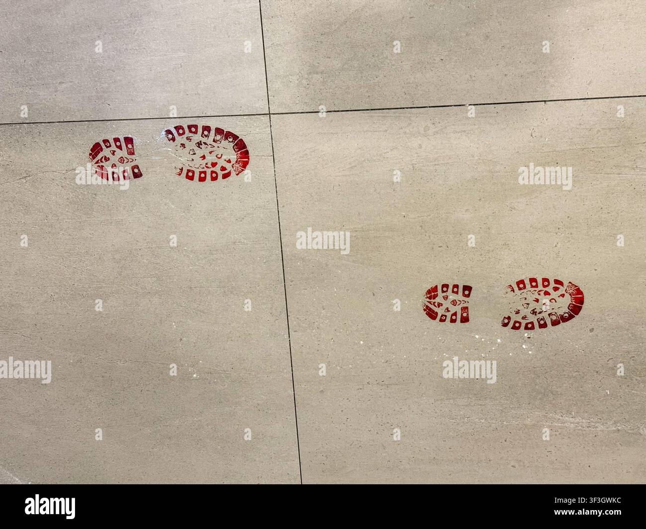 red bloody footprints on grey floor, halloween banner concept of halloween, crime, party Stock Photo