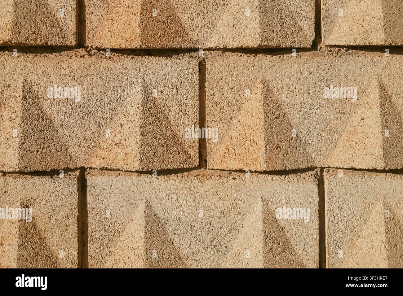 Concrete Yellow Sand-Colored Block Wall Texture Background Stock Photo