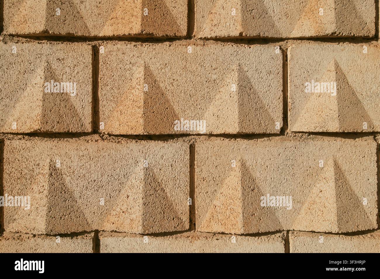 Concrete Yellow Sand-Colored Block Wall Texture Background Stock Photo