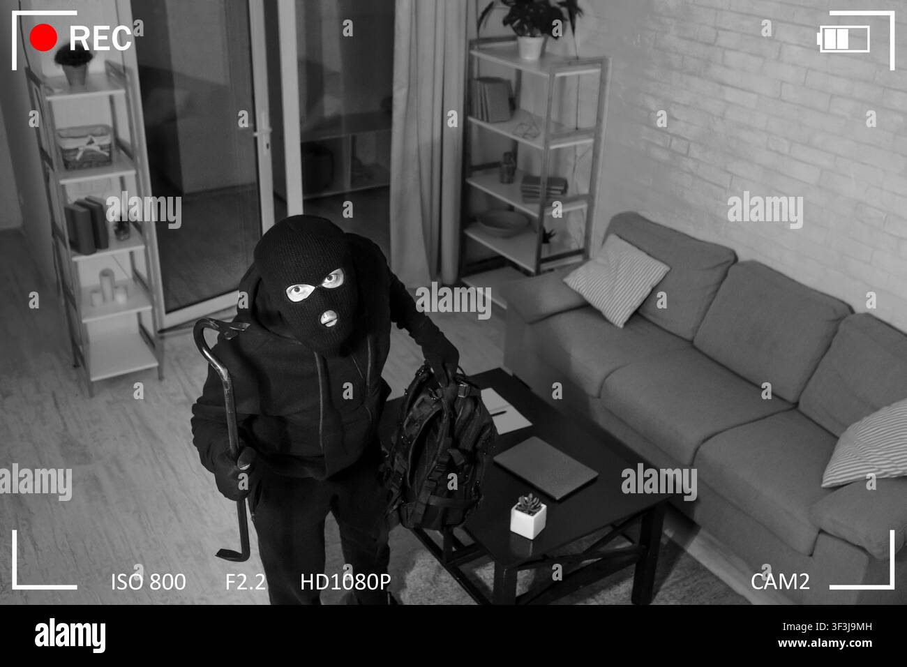 Thief With Crowbar Entering House View From Camera Stock Photo