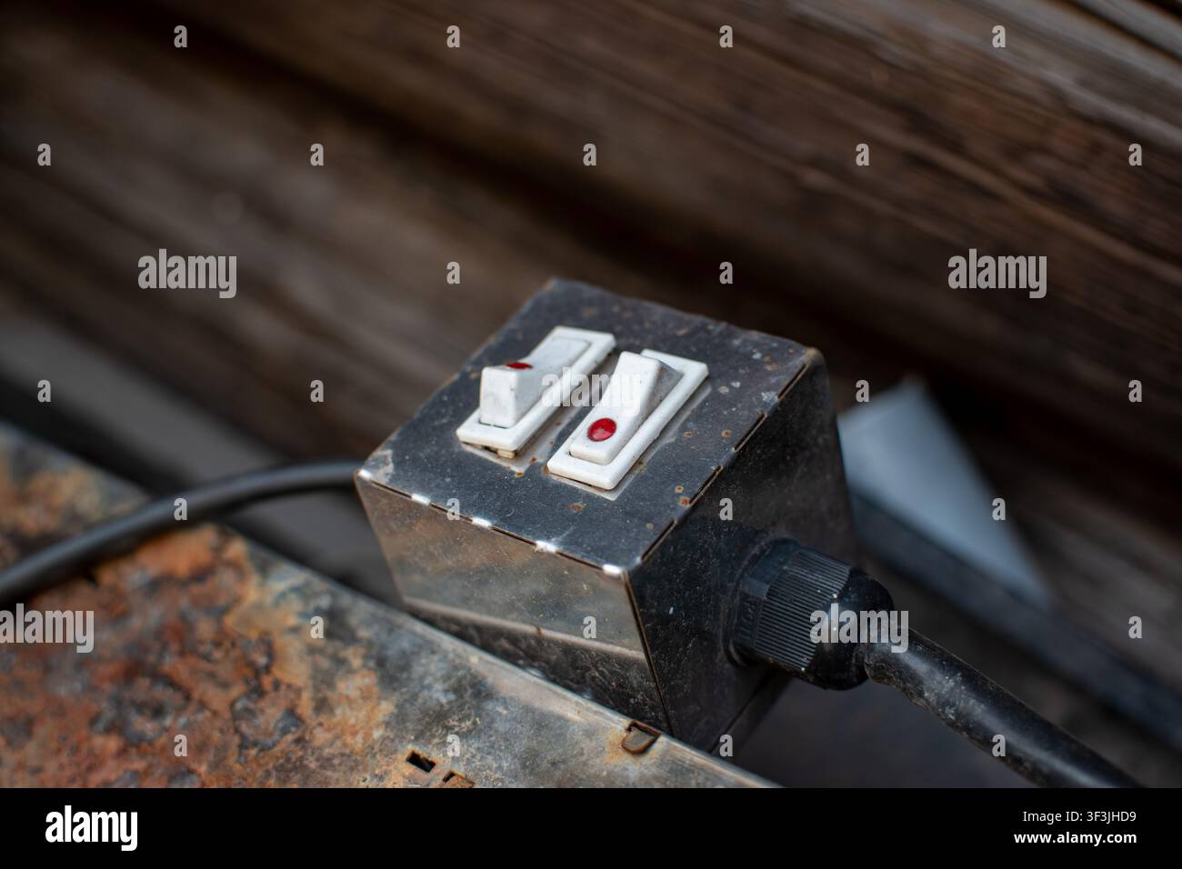 Industrial double toggle switch box on a rusty surface Stock Photo