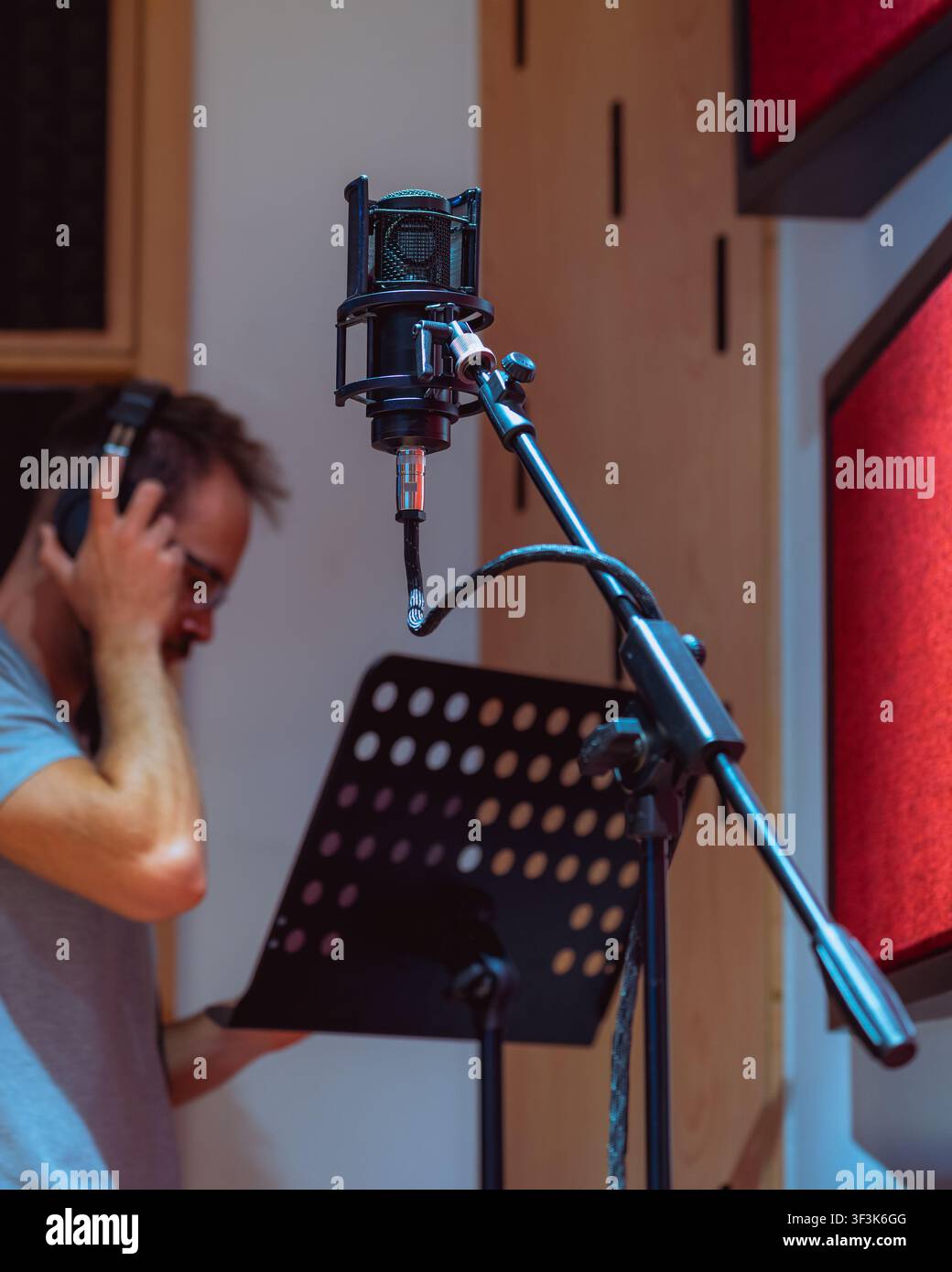 Man behind microphone at recording studio Stock Photo