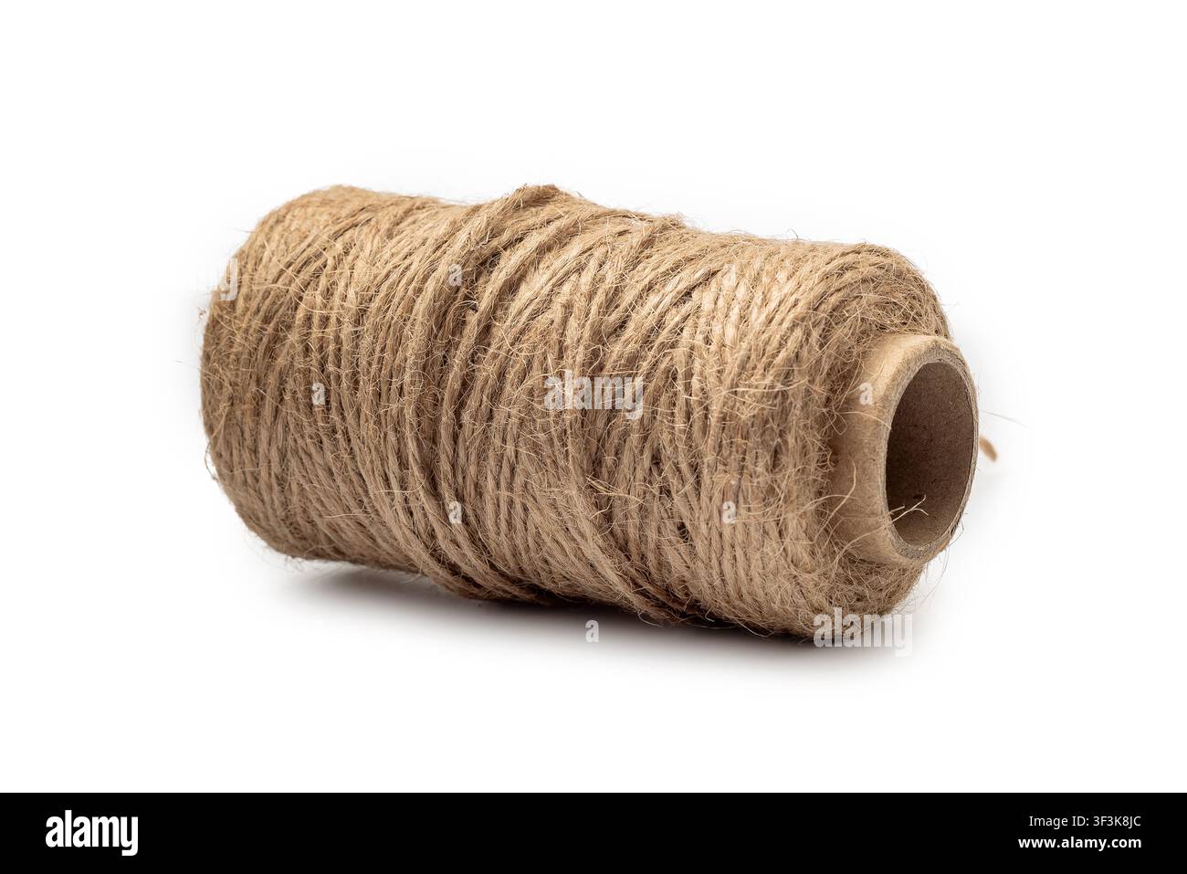 Brown spool of natural jute twine isolated on white background. Material for crafts, design, DIY concept. Stock Photo