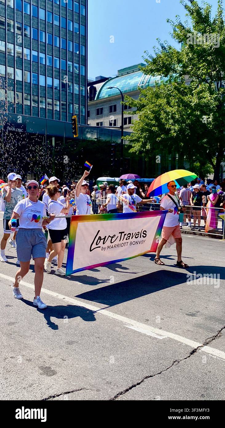 People celebrate during the Montreal Pride Parade in downtown Montreal, Quebec, Canada, in August, promoting diversity, equality, inclusion - Smartphone Captured Stock Image