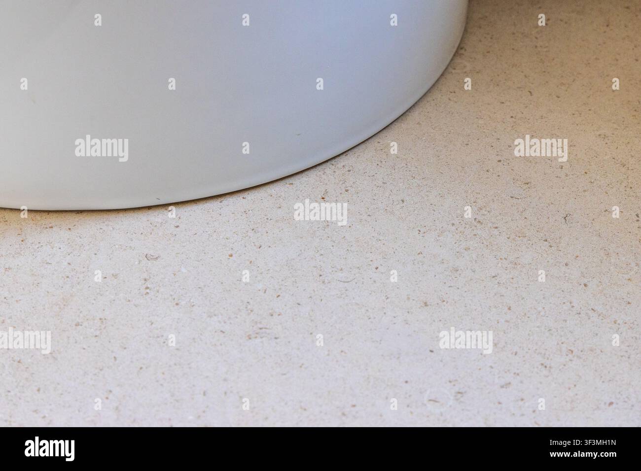 Abstract detail of a soft, rounded edge contrasting with a speckled, granular surface Stock Photo
