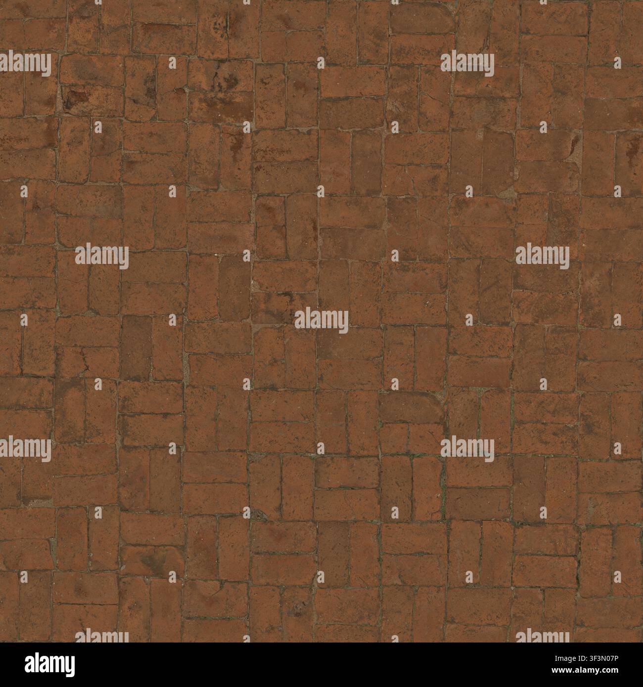 A red clay brick floor paved in a classic herringbone or grid pattern. Stock Photo