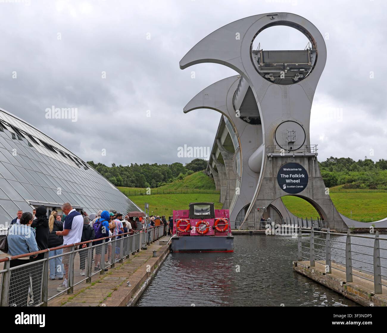 Visitors queue beside the Falkirk Wheel boat lift at Falkirk, Scotland, UK. Stock Photo