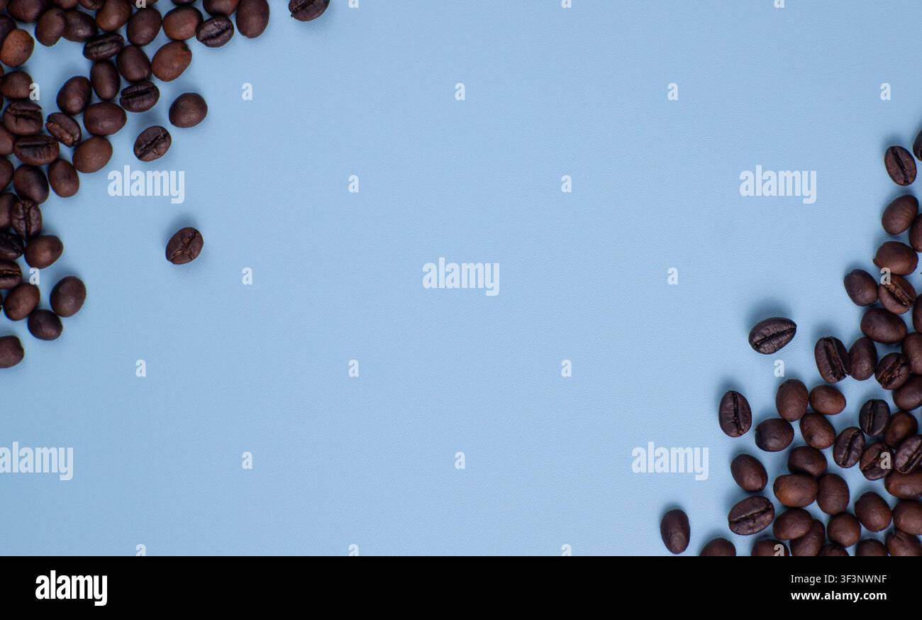 Roasted Coffee Beans Border on Blue Background with Empty Space Stock Photo