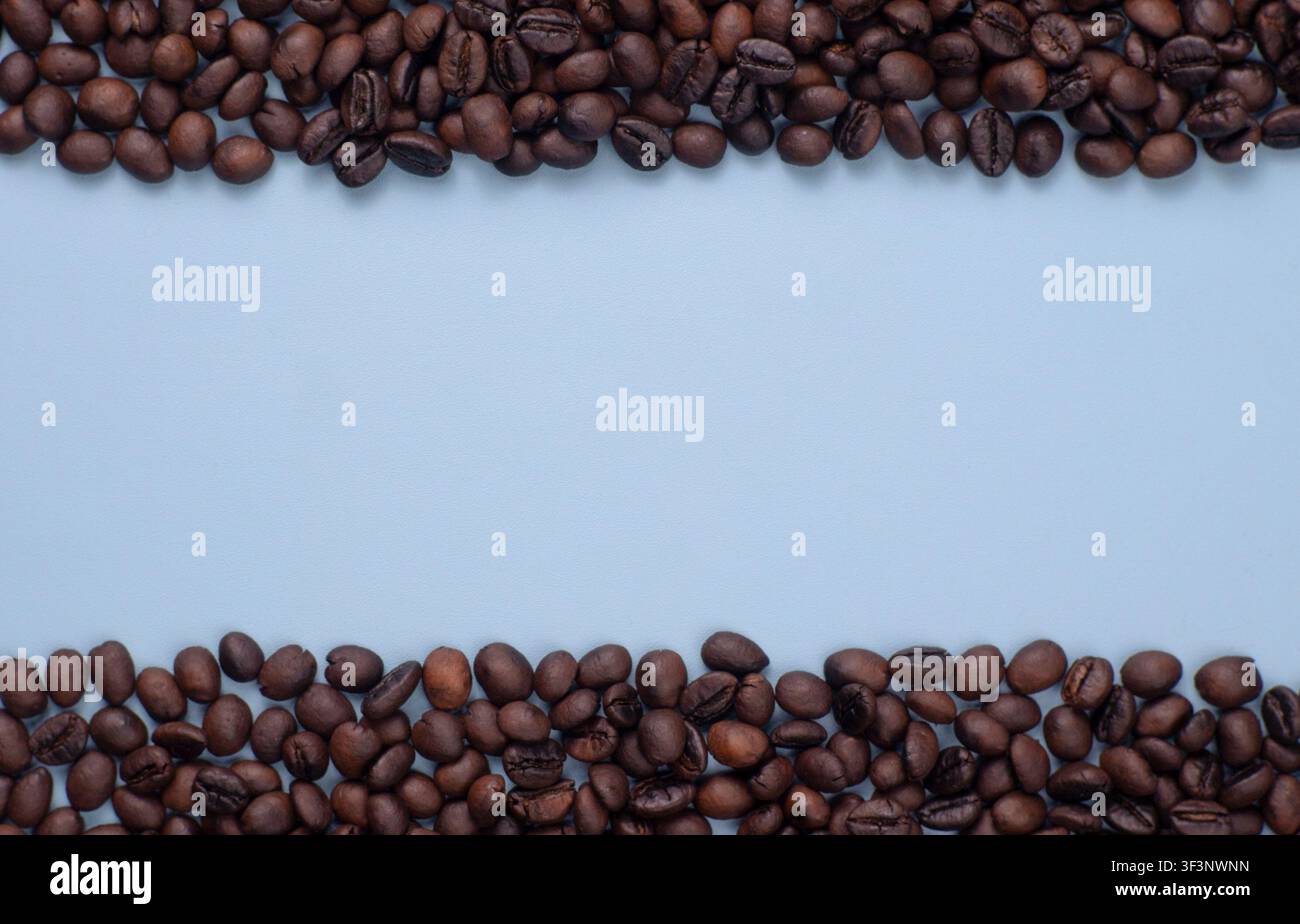 Roasted Coffee Beans Frame on Blue Background with Copy Space Stock Photo