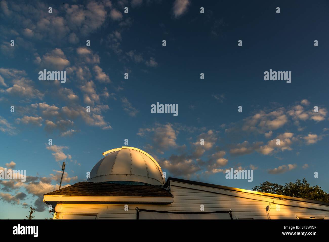 The dome of the Deep Sky Eye Observatory stands out against the sky above Tusket, in the Municipality of Argyle, Nova Scotia, Canada, at sunset. The observatory, which has been in operation since 2015, is situated in North America’s first Starlight-certified destination Stock Photo