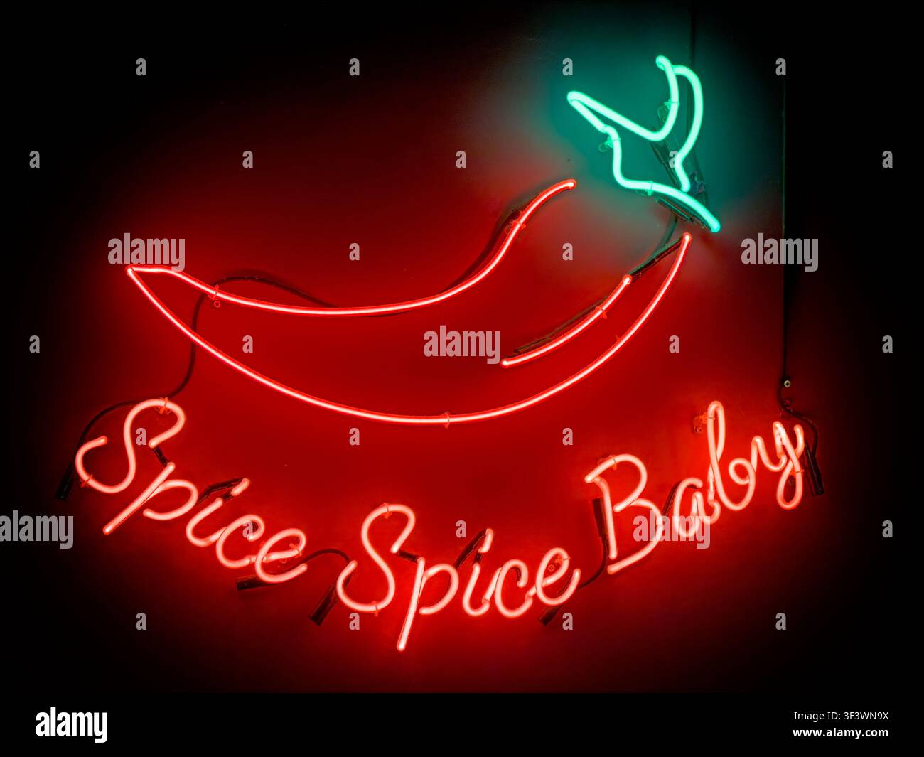 Spice Spice Baby neon sign inside an Indian restaurant or bar, England, UK. Stock Photo