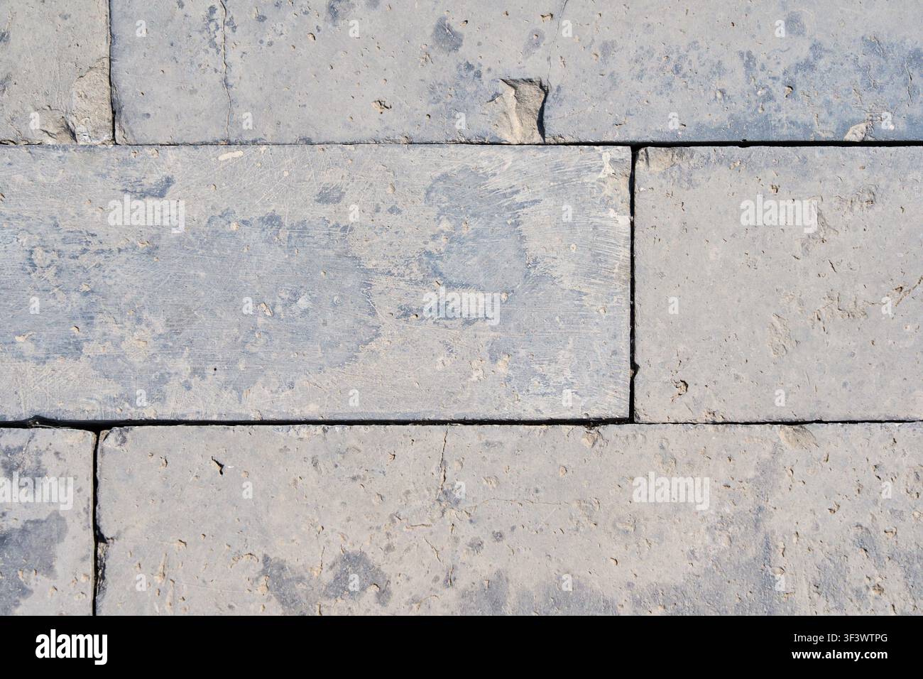 Light Gray Limestone Block Pavement Texture Background with Natural Stone Pattern. Stock Photo