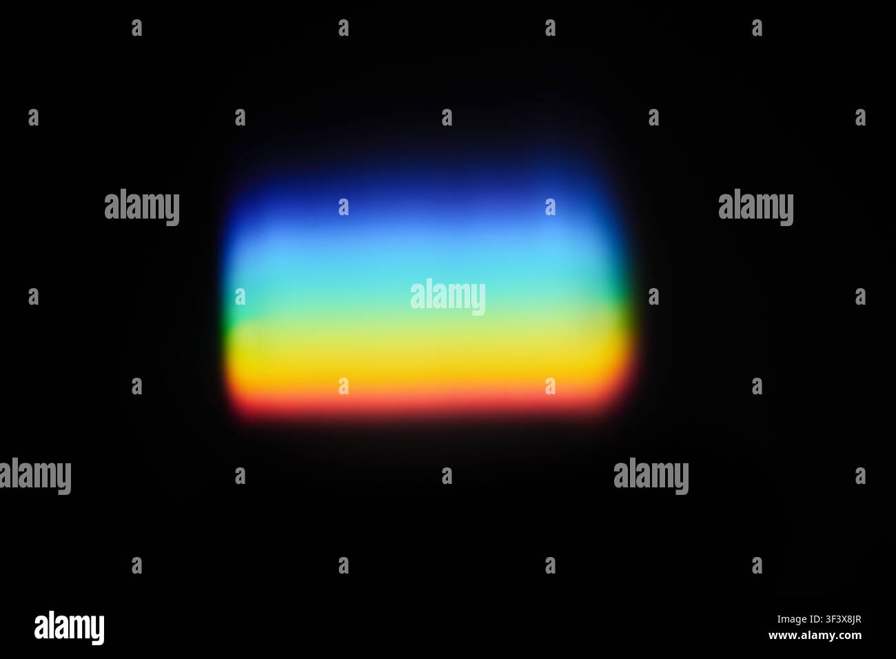 Light refracting through prism creating colorful spectrum effect on black background Stock Photo
