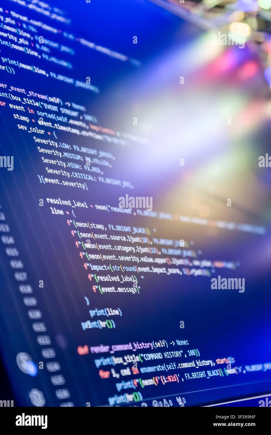 Abstract futuristic programming code on computer screen. Macro shot of a dark mode IDE with python script, cybersecurity threat analysis, and colorful Stock Photo