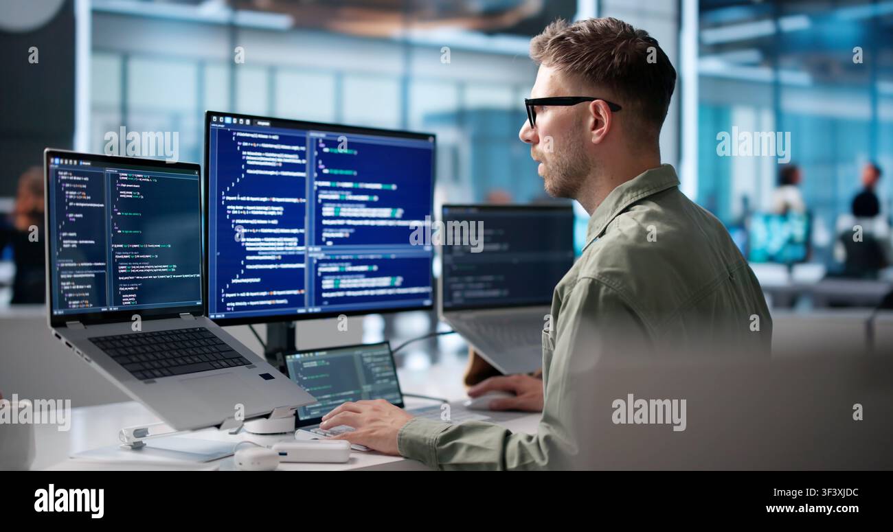 Young Software Engineer Coding On Laptop To Build Secure Business Platform. Stock Photo
