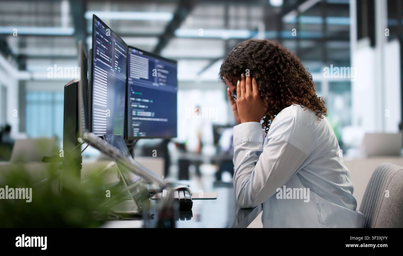 Tired African Female Coder Struggles With Headache While Debugging Code Late. Stock Photo