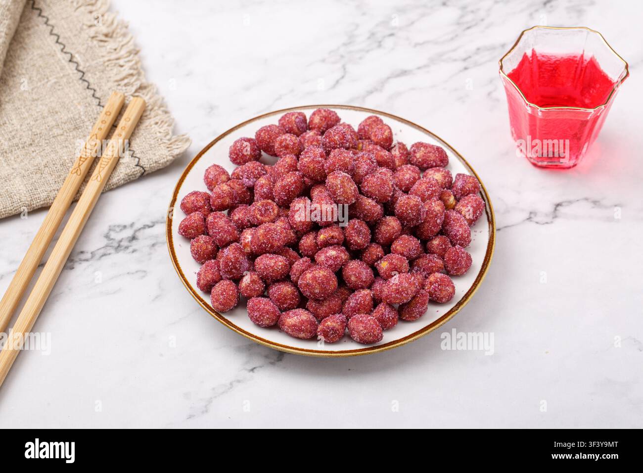 Purple coated crispy peanuts served in small plate Stock Photo