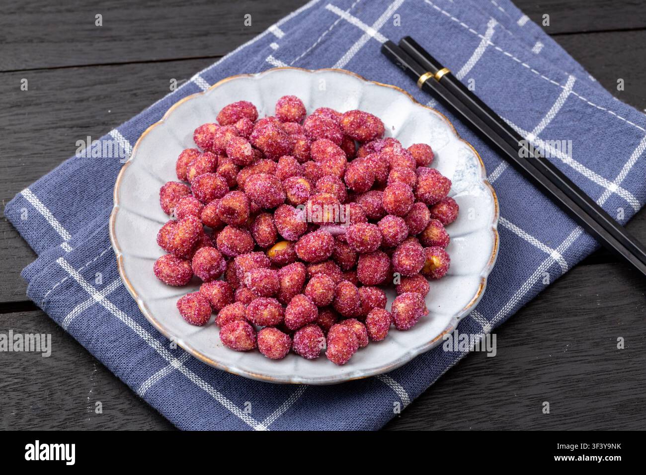 Purple coated crispy peanuts served in small plate Stock Photo