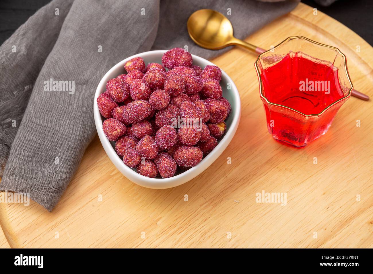 Purple coated crispy peanuts served in small plate Stock Photo