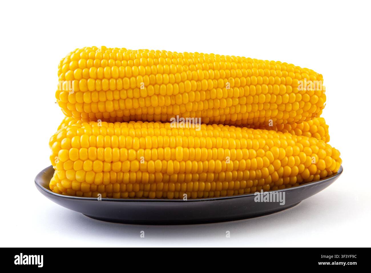 Boiled yellow waxy sweet corn cobs stack isolated on white background Stock Photo