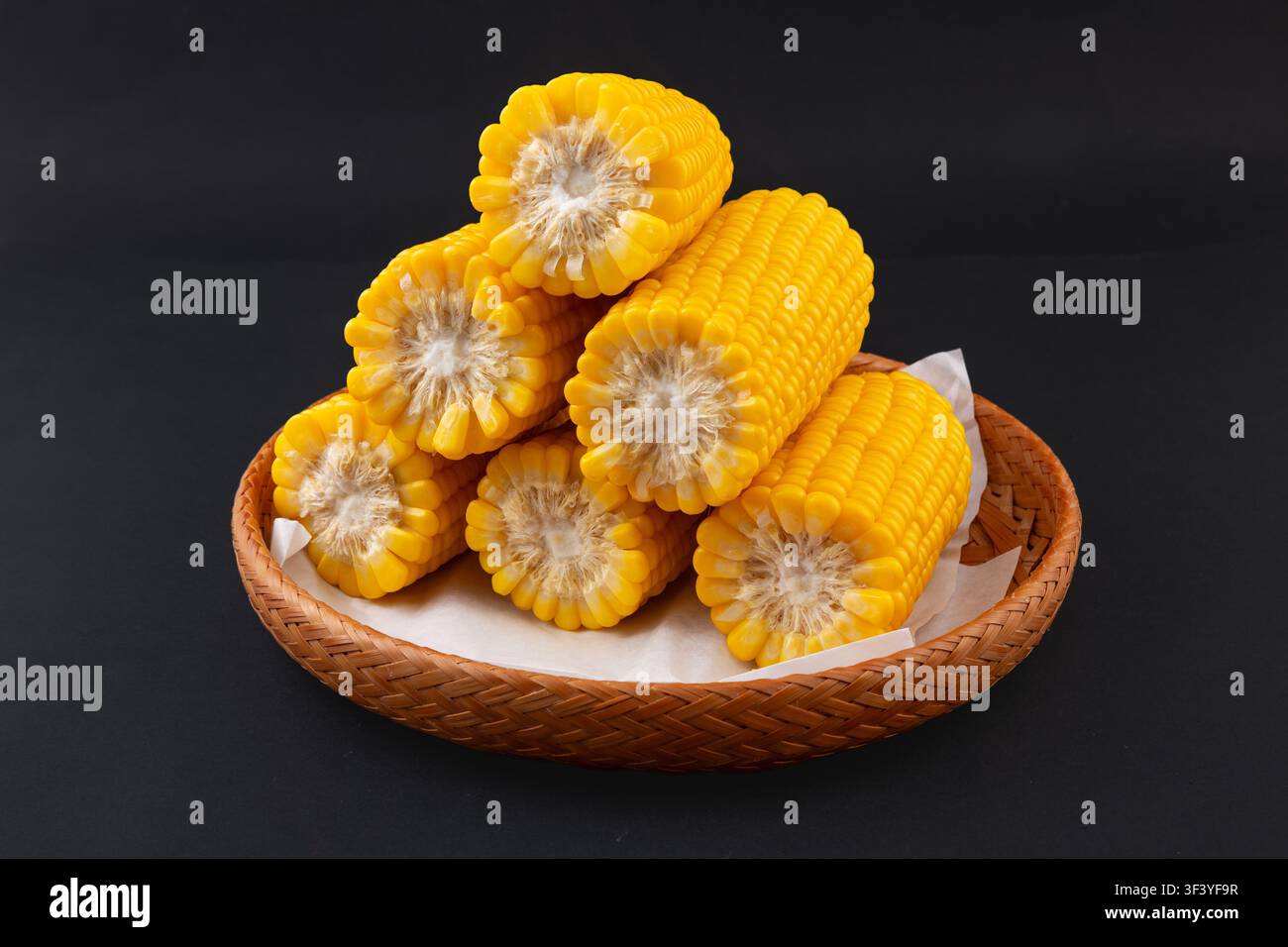 Boiled yellow waxy sweet corn cobs stack isolated on white background Stock Photo
