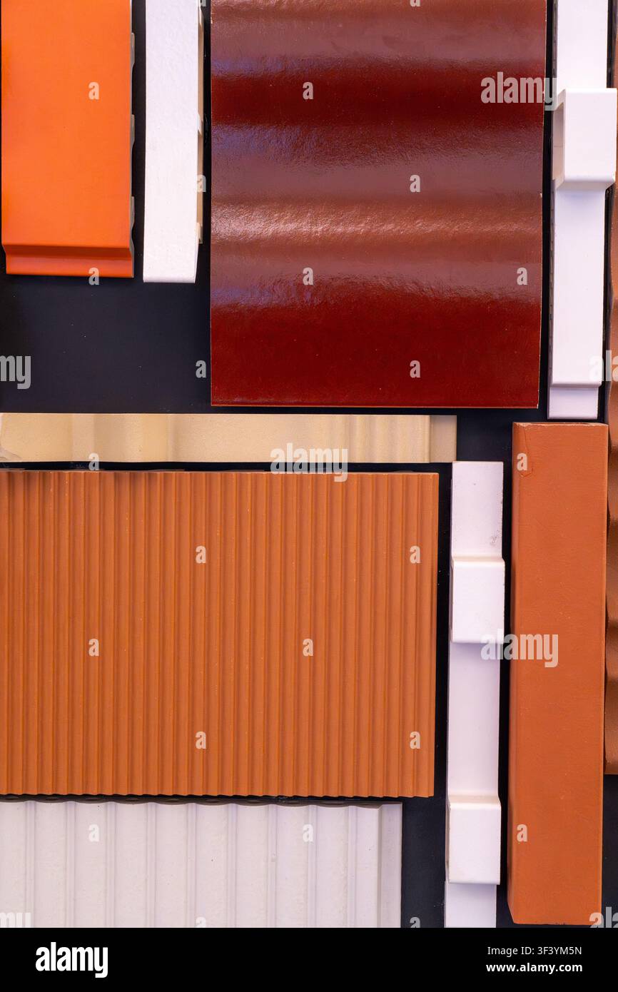 Various exterior wall panel samples with rich earth tone colors, corrugated and smooth finishes, architectural material catalog Stock Photo