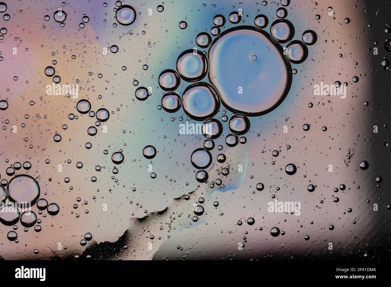 Oil bubbles and multicolored surface creating an abstract liquid texture Stock Photo