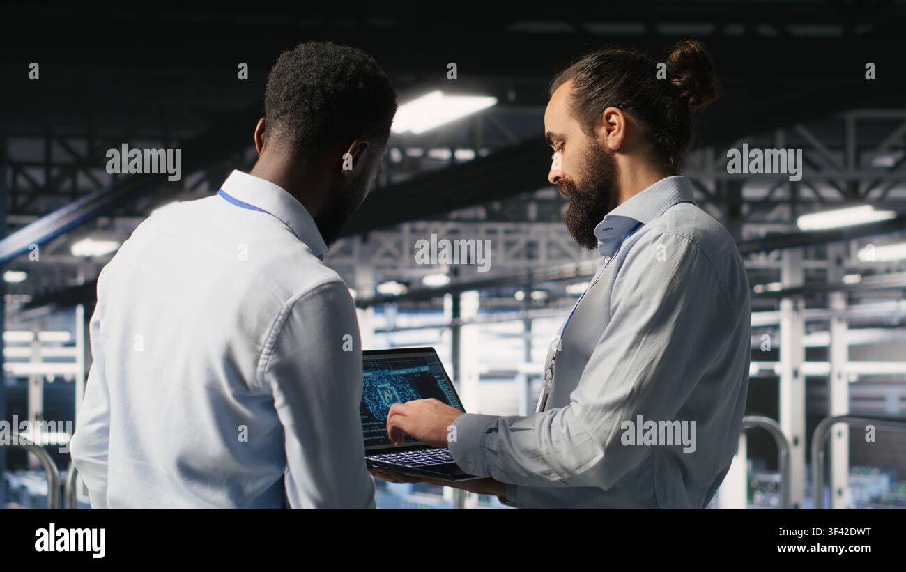 Data center workers cooperating, doing maintenance on rigs handling AI processing tasks. Server hub admins doing brainstorming, managing storage arrays supporting deep learning technology Stock Photo