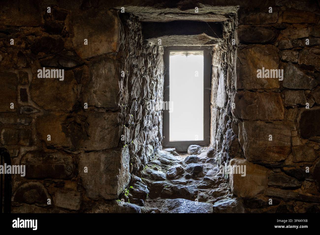 Deeply Recessed Window in Thick Ancient Stone Wall Stock Photo