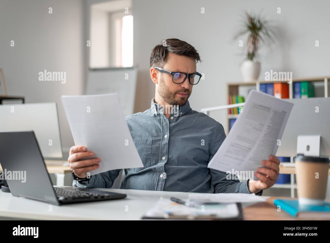 Focused Man Analyzing Documents At Home Office, Business Concept Stock Photo