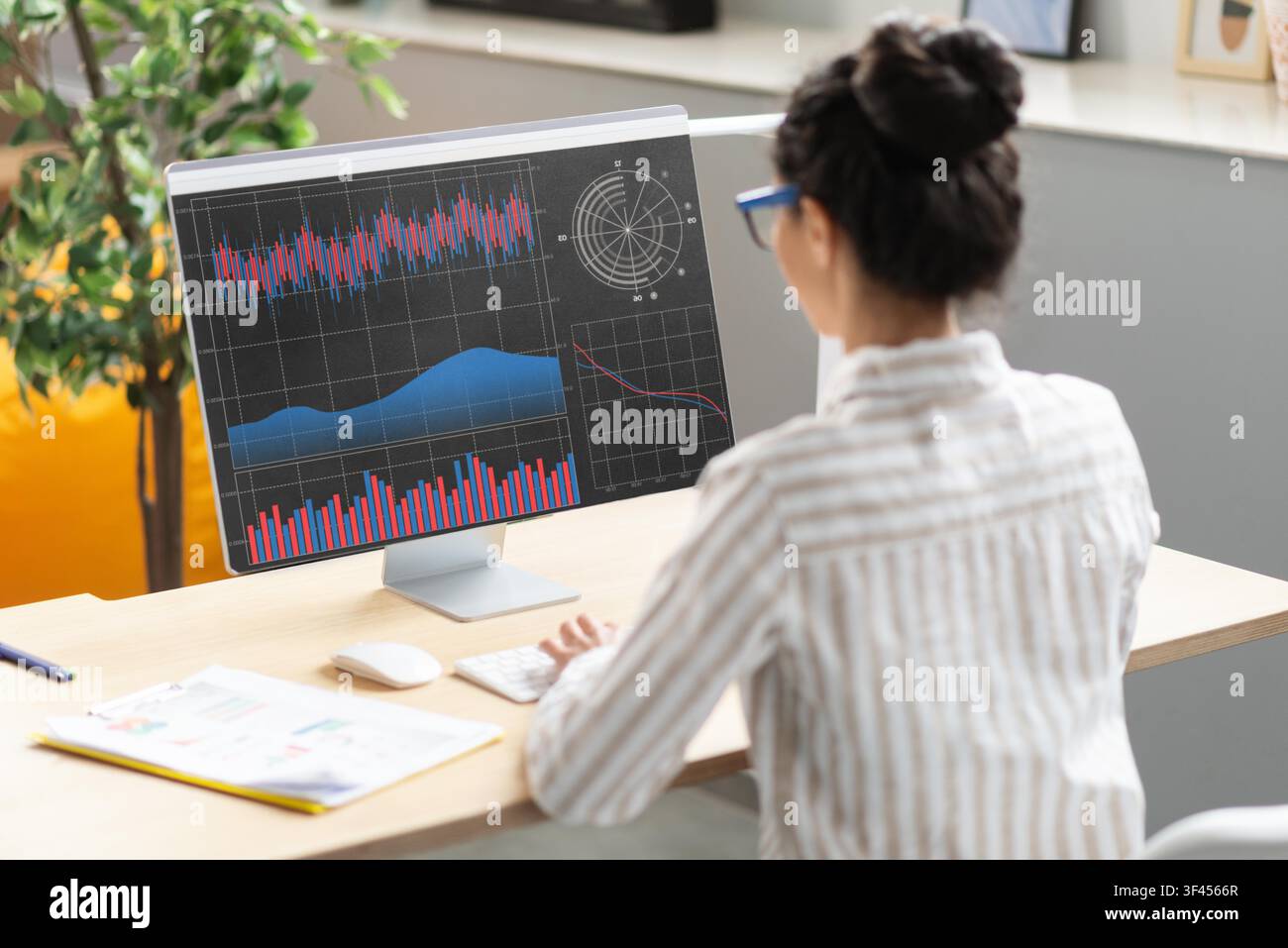 Unrecognizable Female Analyzing Data On Computer In Modern Office, Business Concept Stock Photo